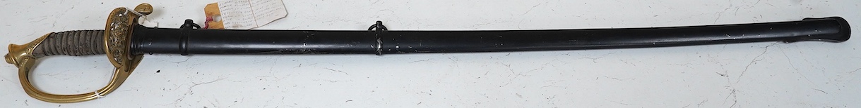 A German (Saxon) infantry officer's sword and scabbard, c.1900, with triple fullered blade, engraved with the cypher of Frederick August II, regulation brass hilt with folding side guard, in its steel scabbard, blade 80c
